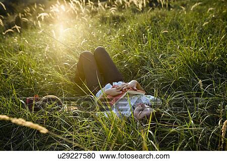 Woman sleeping in grass. View Large Photo Image Stock Image - Woman sleeping in grass.. Fotosearch