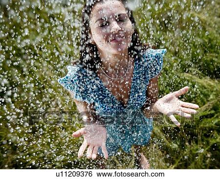 Woman standing in rain View Large Photo Image Stock Photograph - Woman standing in rain. Fotosearch