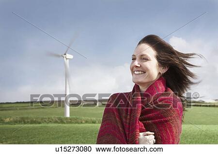 Woman with hair blowing on a wind farm View Large Photo Image Stock Image - Woman with hair blowing on a wind farm. Fotosearch