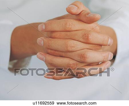 Stock Photo - Close-Up, Hand Clasped, Hands Clasped, Human Finger. Fotosearch
