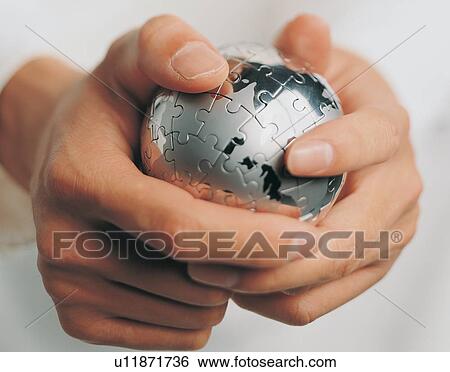 Stock Photograph - Global, Metal, Jigsaw, Part Of, Hand, Jigsaw Puzzle. Fotosearch