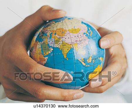 Stock Image - Holding, One Person, Indoor, World At Your Fingertips, Ideas, Team Work. Fotosearch