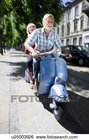 Stock Photograph - Couple on scooter. Fotosearch
