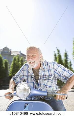 Stock Photography - Man on scooter. Fotosearch