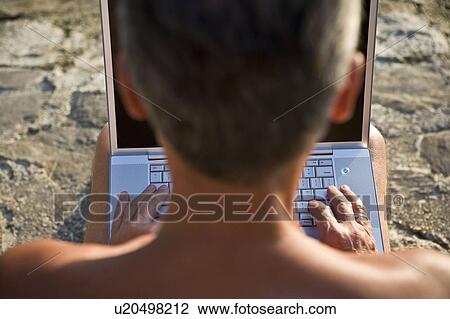 Stock Image - Man using laptop close-up. Fotosearch
