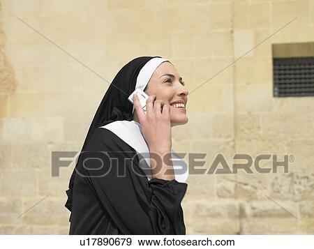 Nun talking on mobile phone smiling, Alicante, Spain, View Large Photo Image Stock Photo - Nun talking on mobile phone smiling, Alicante, Spain,. Fotosearch
