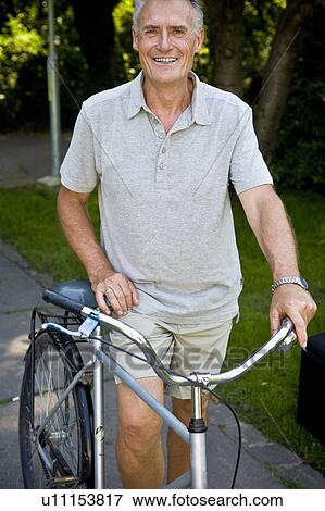 Portrait of man with bike View Large Photo Image Stock Photo - Portrait of man with bike. Fotosearch