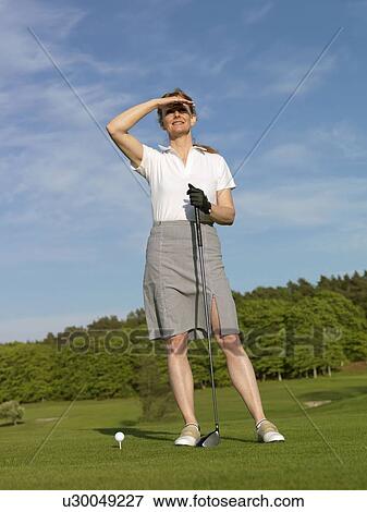 Stock Photo - Woman at golf tee. Fotosearch