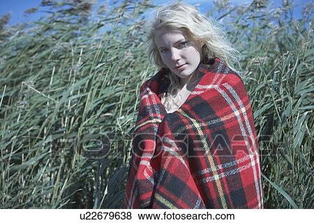 Stock Photo - Young Woman in tartan blanket.. Fotosearch