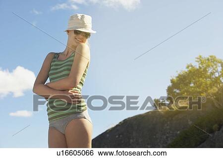 Stock Photograph - Young woman wearing sun hat.. Fotosearch