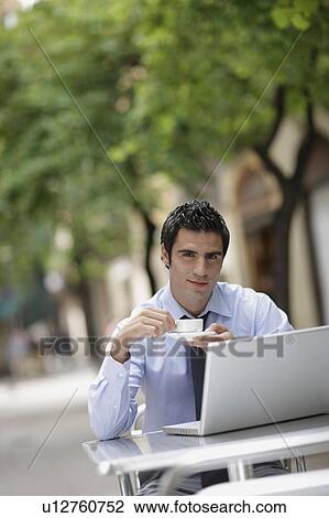 Business man at caf? with laptop View Large Photo Image Stock Image - Business man at caf? with laptop. Fotosearch