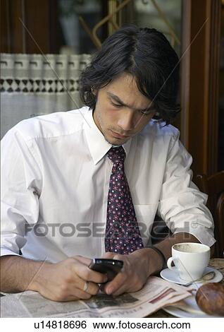 Businessman with blackberry and coffee. View Large Photo Image Stock Photograph - Businessman with blackberry and coffee.. Fotosearch