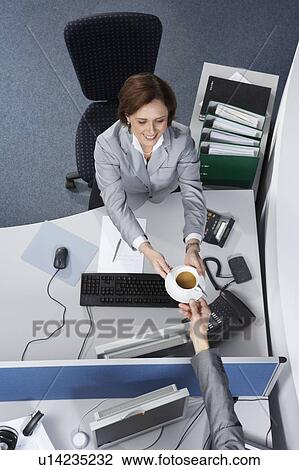 Businesswoman passing a coffee cup View Large Photo Image Stock Image - Businesswoman passing a coffee cup. Fotosearch