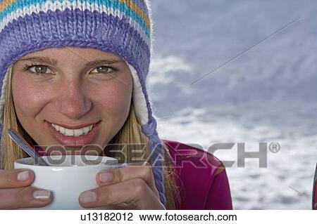 Stock Image - Girl holding cup of tea. Fotosearch