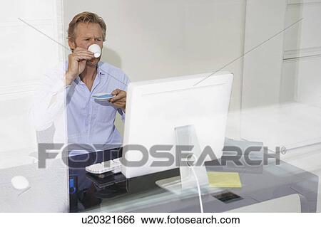Man at computer drinking Espresso with reflections. View Large Photo Image Stock Photograph - Man at computer drinking Espresso with reflections.. Fotosearch