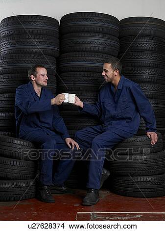 Picture - Mechanics on break drinking coffee. Fotosearch