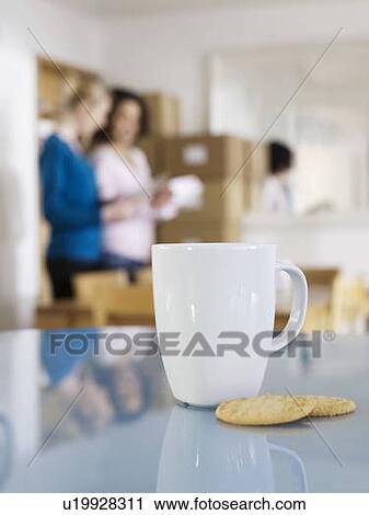 Mug and biscuits with homeworkers View Large Photo Image Stock Image - Mug and biscuits with homeworkers. Fotosearch