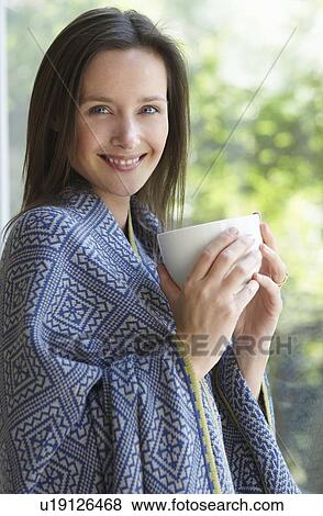 Woman with a cup, smiling at camera View Large Photo Image Stock Photo - Woman with a cup, smiling at camera. Fotosearch