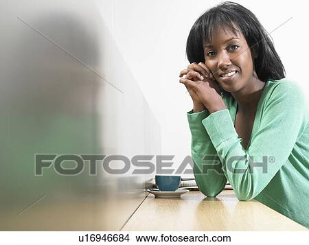 Woman with coffee, smiling View Large Photo Image Picture - Woman with coffee, smiling. Fotosearch