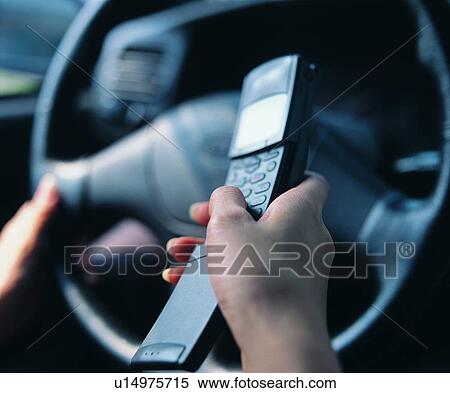 Stock Photography - dail, hand, car, steering wheel, cell phone, mobile phone. Fotosearch