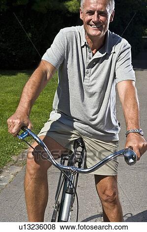 Stock Photo - Man on bicycle, portrait. Fotosearch