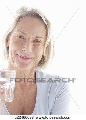 Mature woman drinking water View Large Photo Image Stock Photo - Mature woman drinking water. Fotosearch
