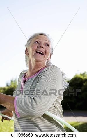 Mature woman with hula-hoop View Large Photo Image Stock Photo - Mature woman with hula-hoop. Fotosearch