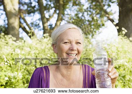 Mature woman with water bottle View Large Photo Image Stock Image - Mature woman with water bottle. Fotosearch