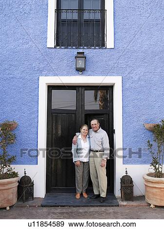 Stock Photo - Senior couple sitting in garden using laptop. Fotosearch