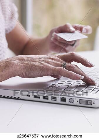 Senior woman purchasing on internet View Large Photo Image Stock Photo - Senior woman purchasing on internet. Fotosearch