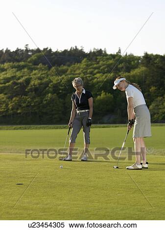 Two women at golf green View Large Photo Image Stock Photography - Two women at golf green. Fotosearch