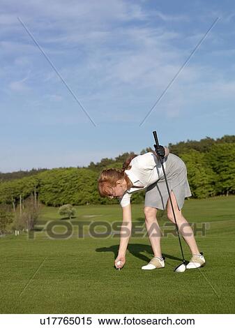 Stock Photography - Woman at golf tee. Fotosearch