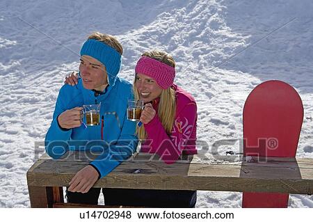 Stock Photo - Couple sitting, smiling. Fotosearch