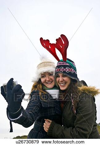 Girls taking self photo View Large Photo Image Stock Photo - Girls taking self photo. Fotosearch