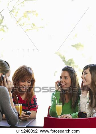 Group of teenage females in cafe View Large Photo Image Stock Image - Group of teenage females in cafe. Fotosearch