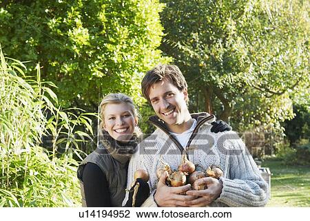 Stock Image - Happy couple gardening. Fotosearch