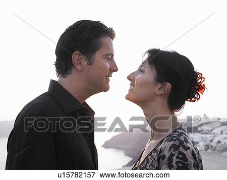 Stock Photo - Man and woman looking at each other. Fotosearch