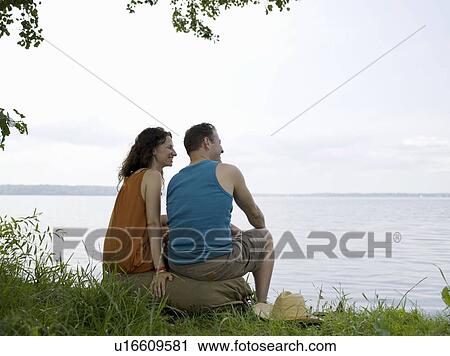 Man and woman sitting together View Large Photo Image Stock Image - Man and woman sitting together . Fotosearch