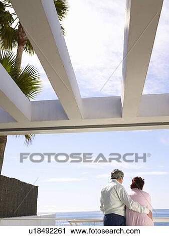 Mature couple looking out to sea View Large Photo Image Stock Image - Mature couple looking out to sea. Fotosearch