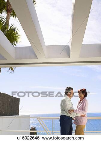 Mature man and woman on balcony View Large Photo Image Stock Photograph - Mature man and woman on balcony. Fotosearch