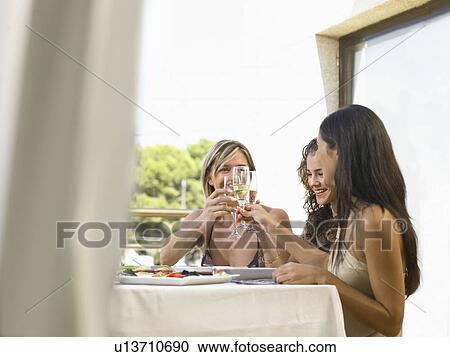 Mother with daughters celebrating View Large Photo Image Stock Image - Mother with daughters celebrating. Fotosearch