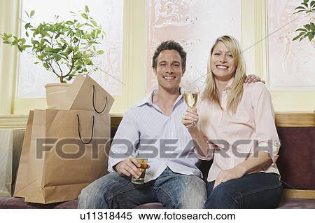 Portrait of couple enjoying a drink View Large Photo Image Stock Photography - Portrait of couple enjoying a drink. Fotosearch