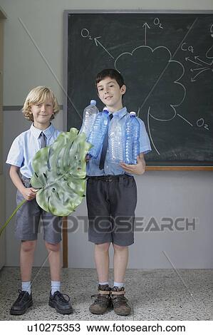 Stock Image - School boys giving science presentation. Fotosearch