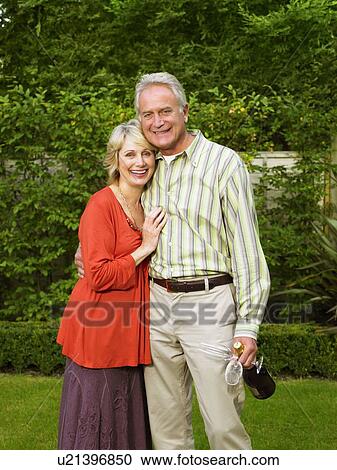 Stock Image - Senior couple with Champagne bottle. Fotosearch