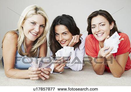 Stock Photo - Three happy woman hold banknotes. Fotosearch