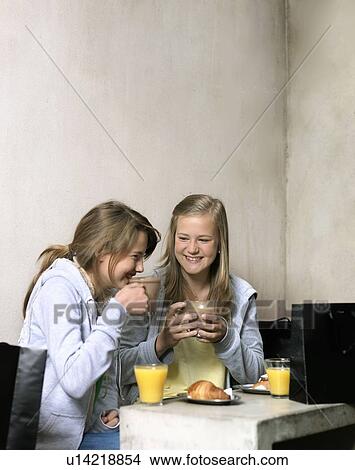 Two girls drinking coffee View Large Photo Image Picture - Two girls drinking coffee. Fotosearch