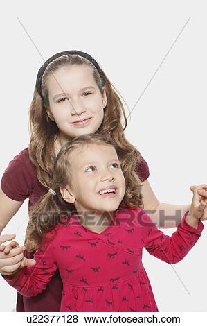 Young girl playing with sister View Large Photo Image Stock Photo - Young girl playing with sister. Fotosearch