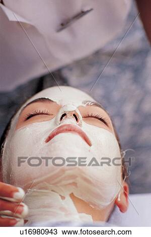 Stock Image - human hands, face pack, face cream, therapeutic, head and shoulders, pampering, indulgence. Fotosearch