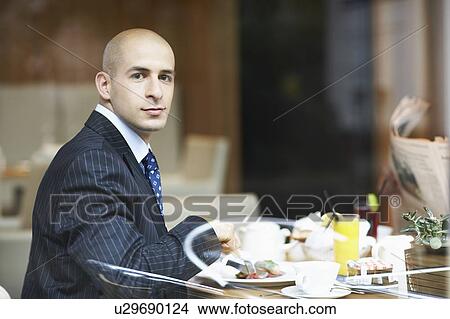 Picture - A businessman in a restaurant. Fotosearch