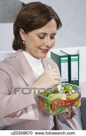 Business woman eating salad View Large Photo Image Stock Image - Business woman eating salad. Fotosearch